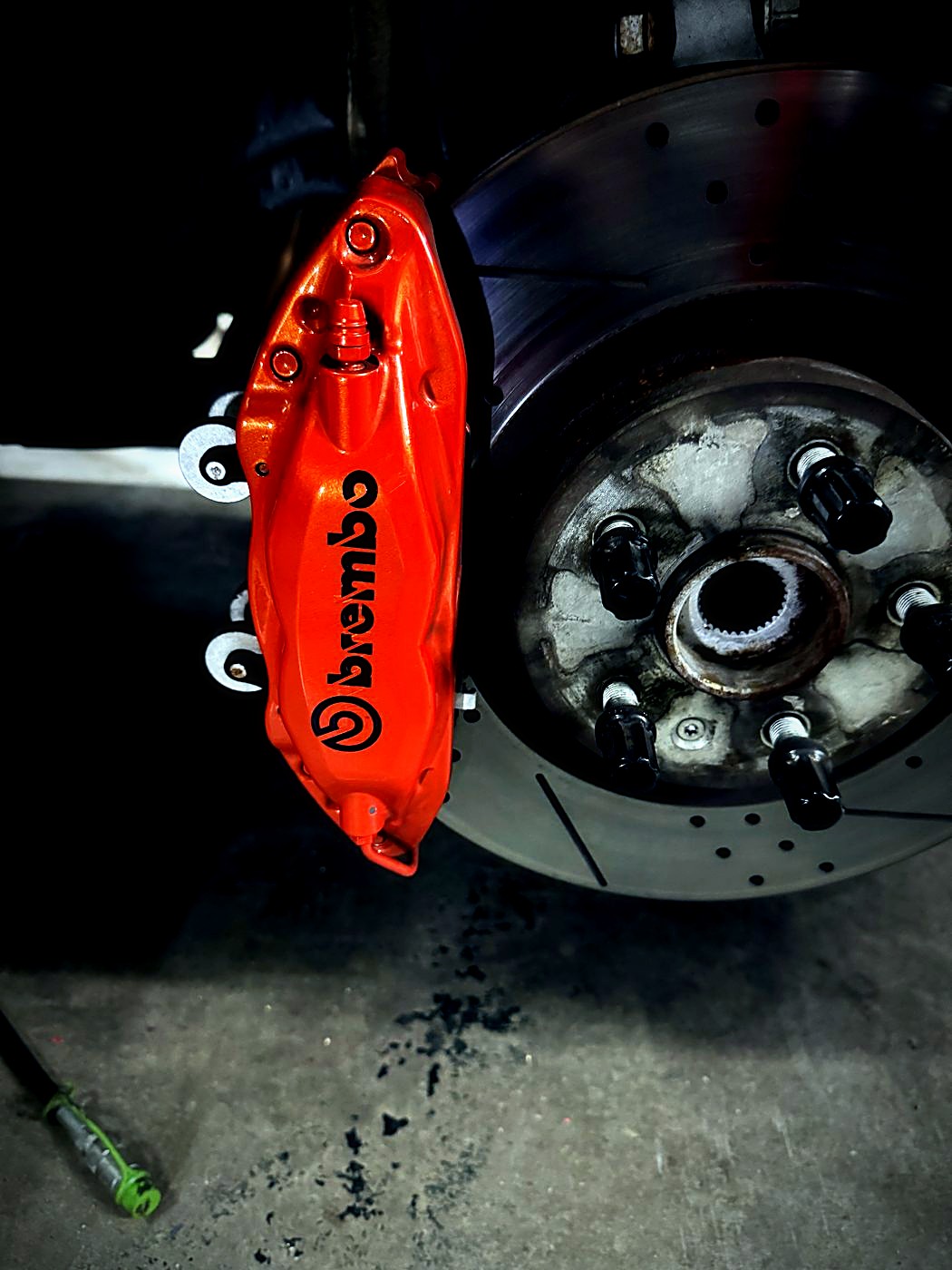 Orange Brembo caliper with drilled rotor