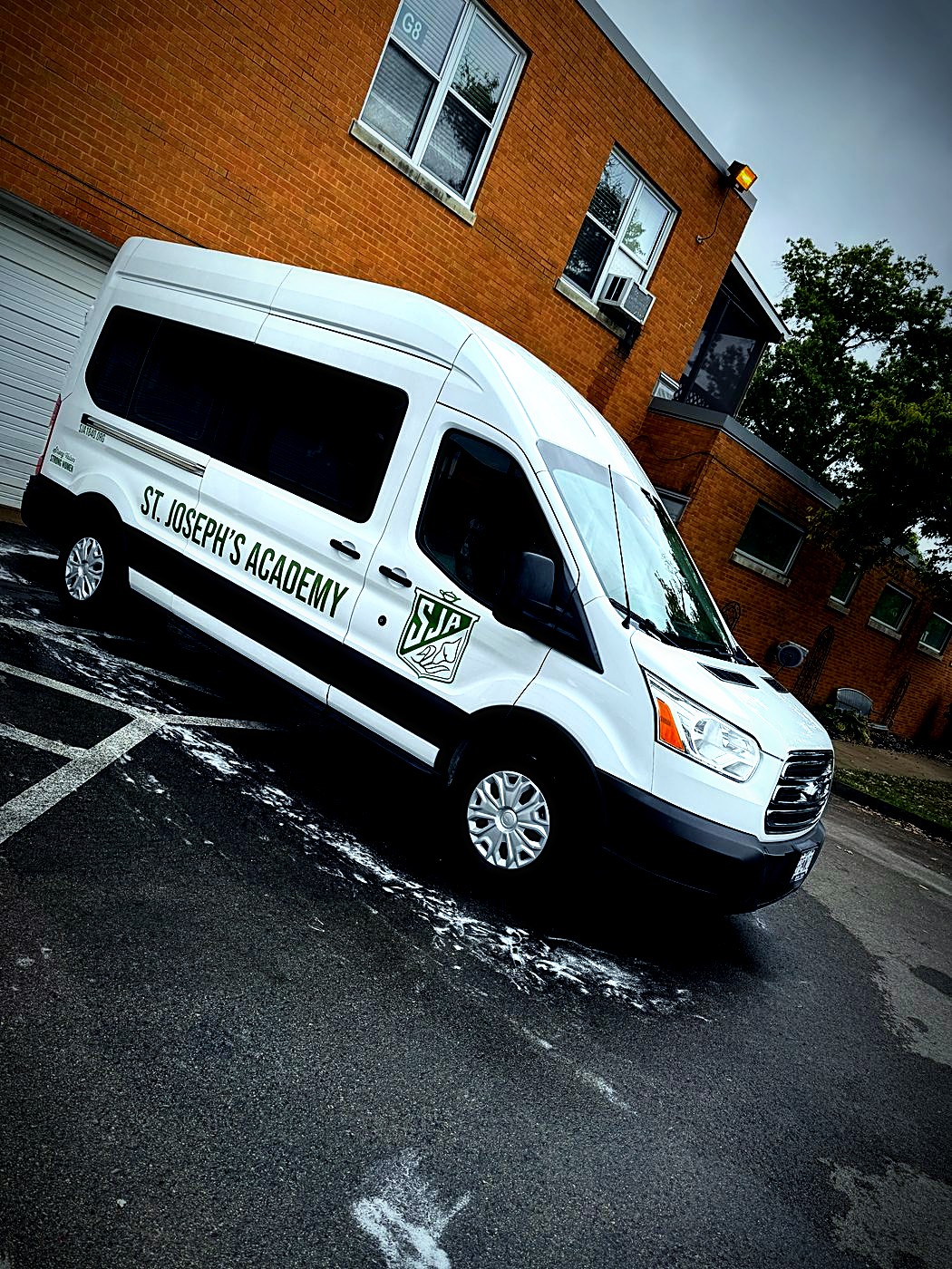 White passenger van after a fleet wash