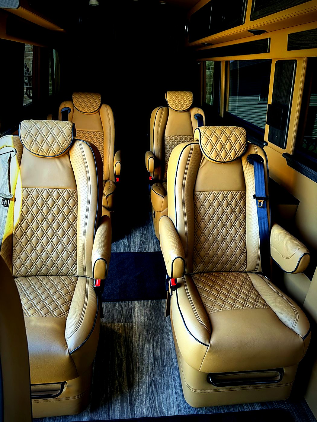 Luxury van interior with quilted tan captain chairs