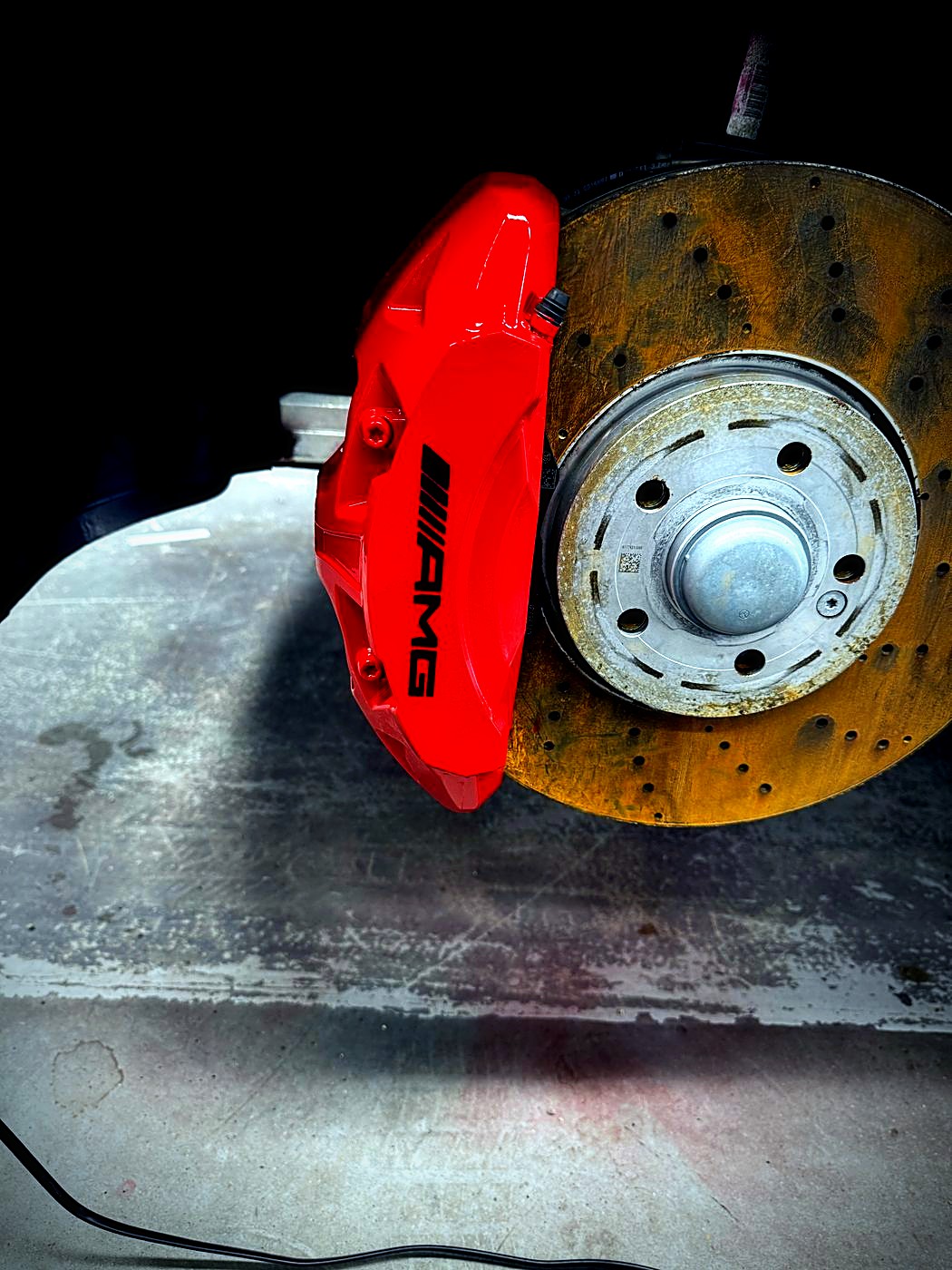 Red AMG brake caliper freshly repainted