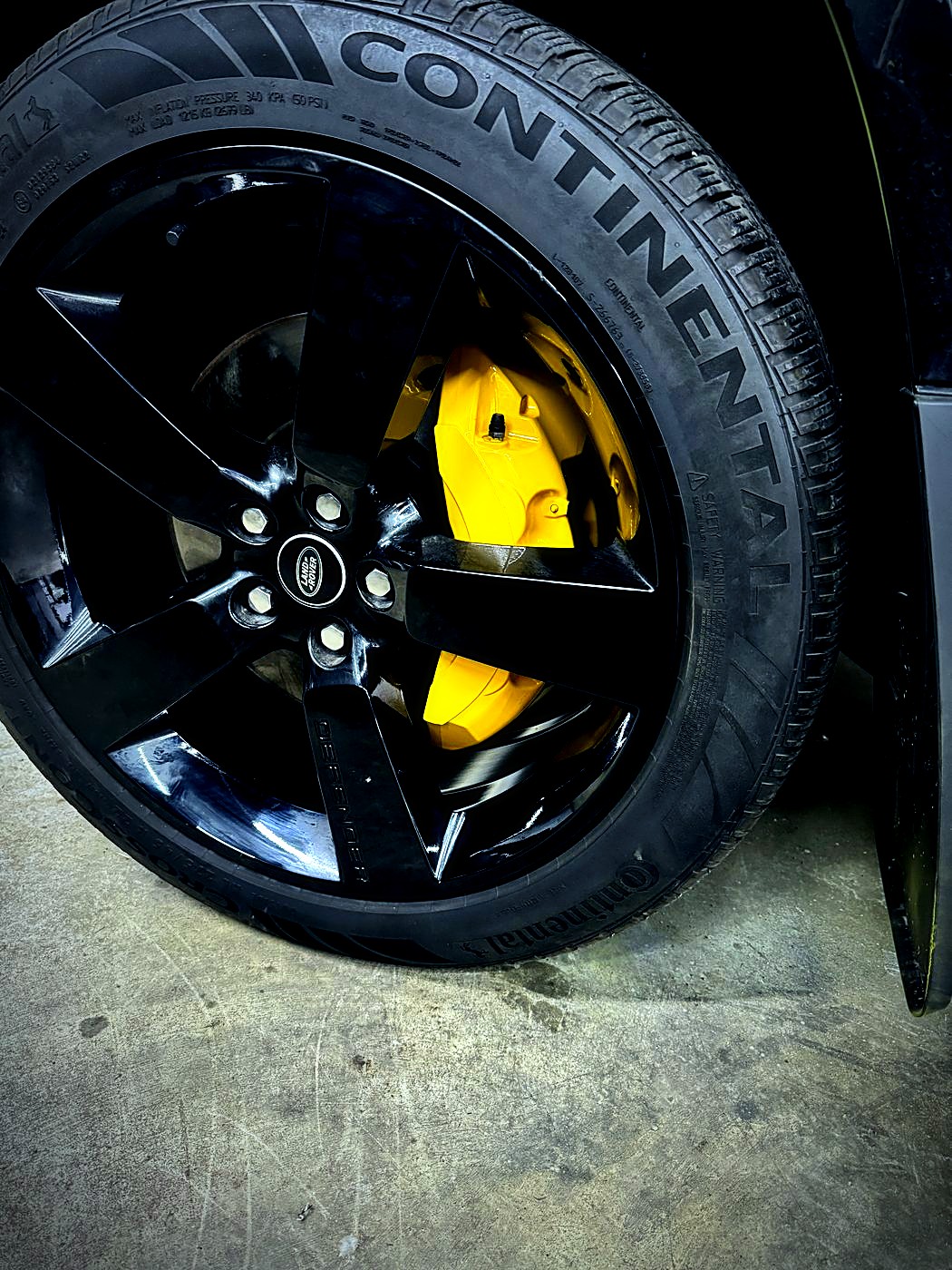 Yellow calipers behind gloss black wheels